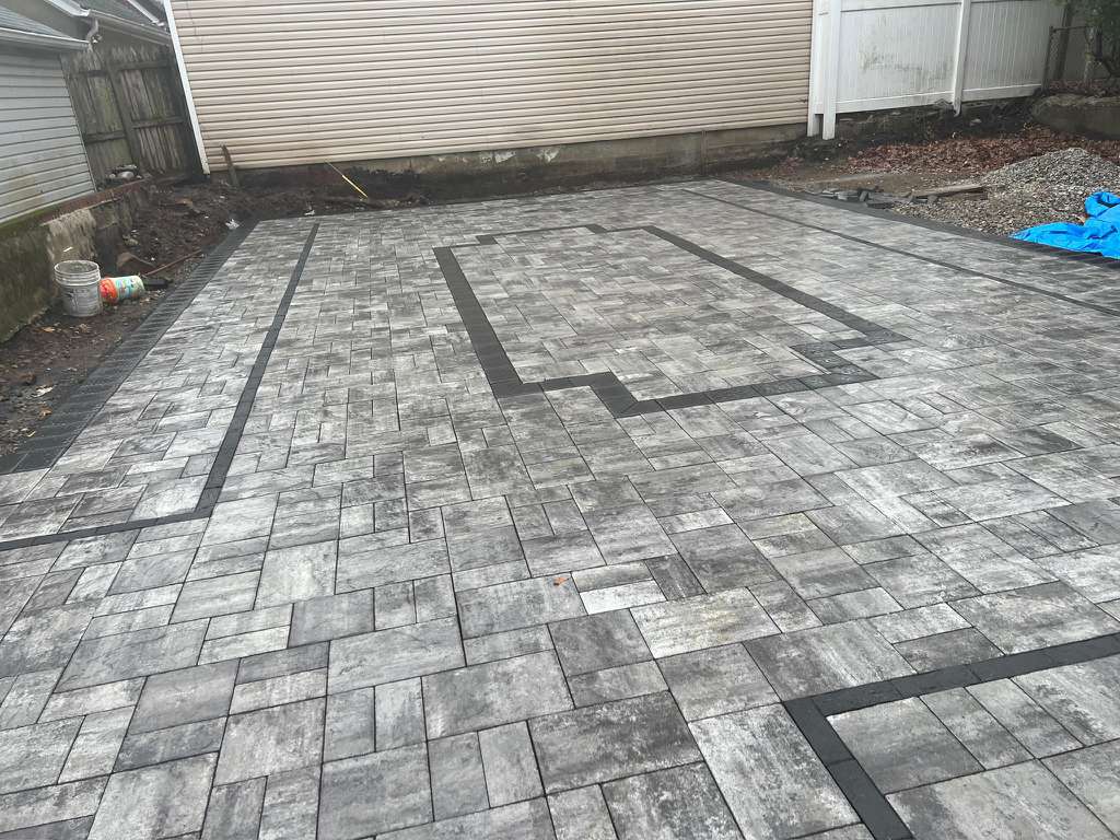 backyard and driveway pavers installation project in floral park ny with custom brick